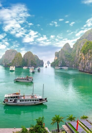 Turquoise waters of Ha Long Bay with ferries