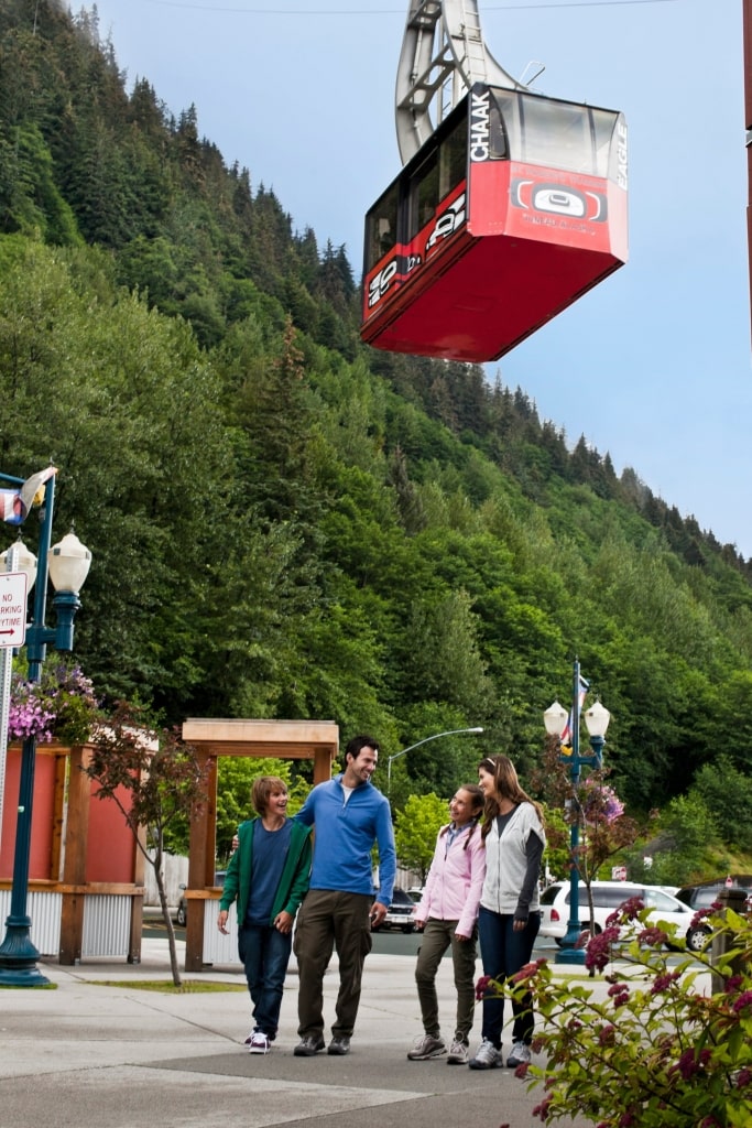 Family walking in the street with view of Mount Roberts Tramway