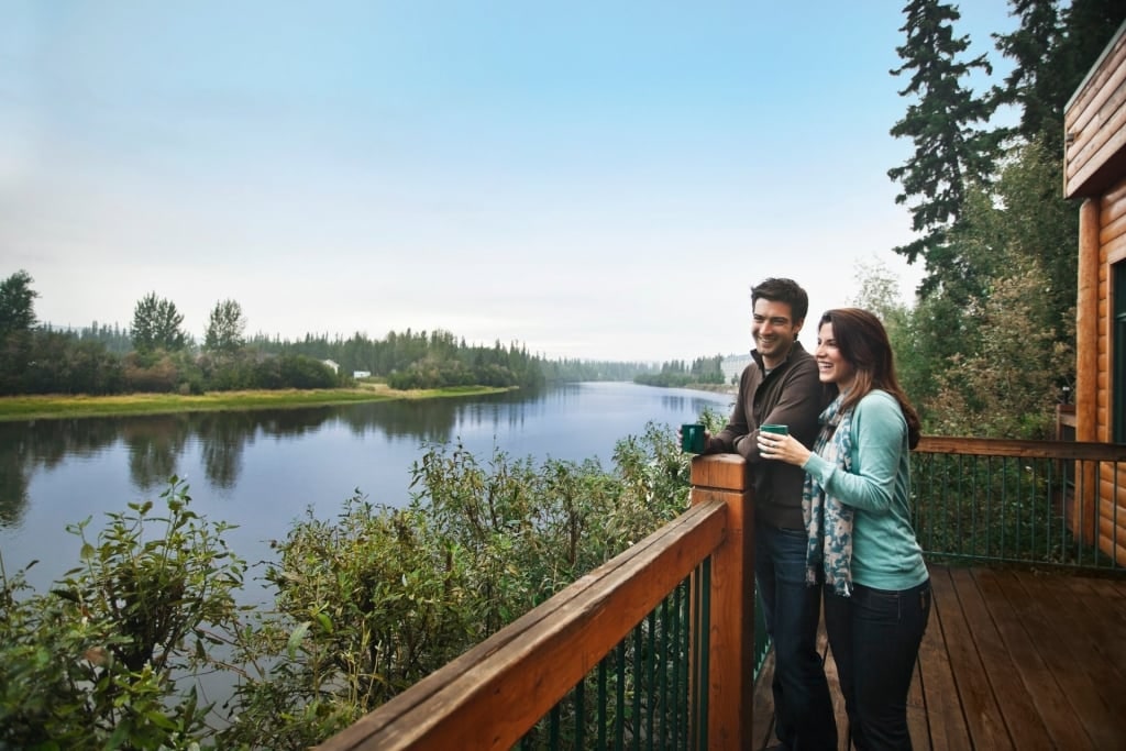 Couple drinking coffee with lake view