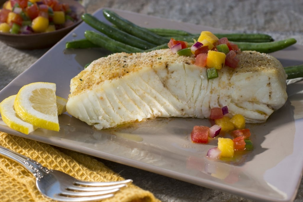 Halibut on plate with green beans on the side