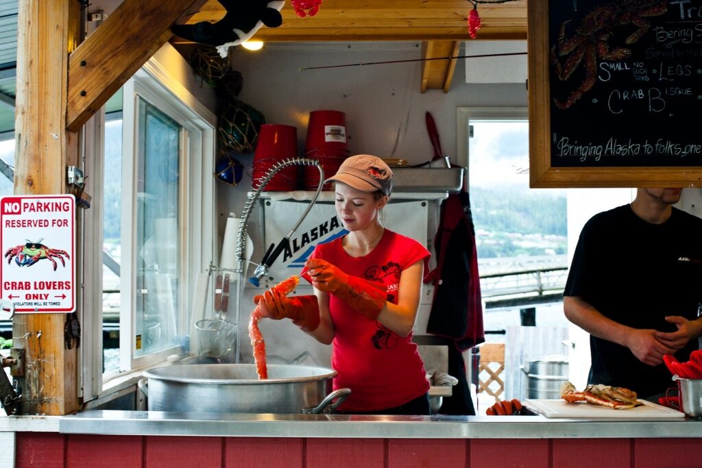 Woman preparing crab at an Alaskan store