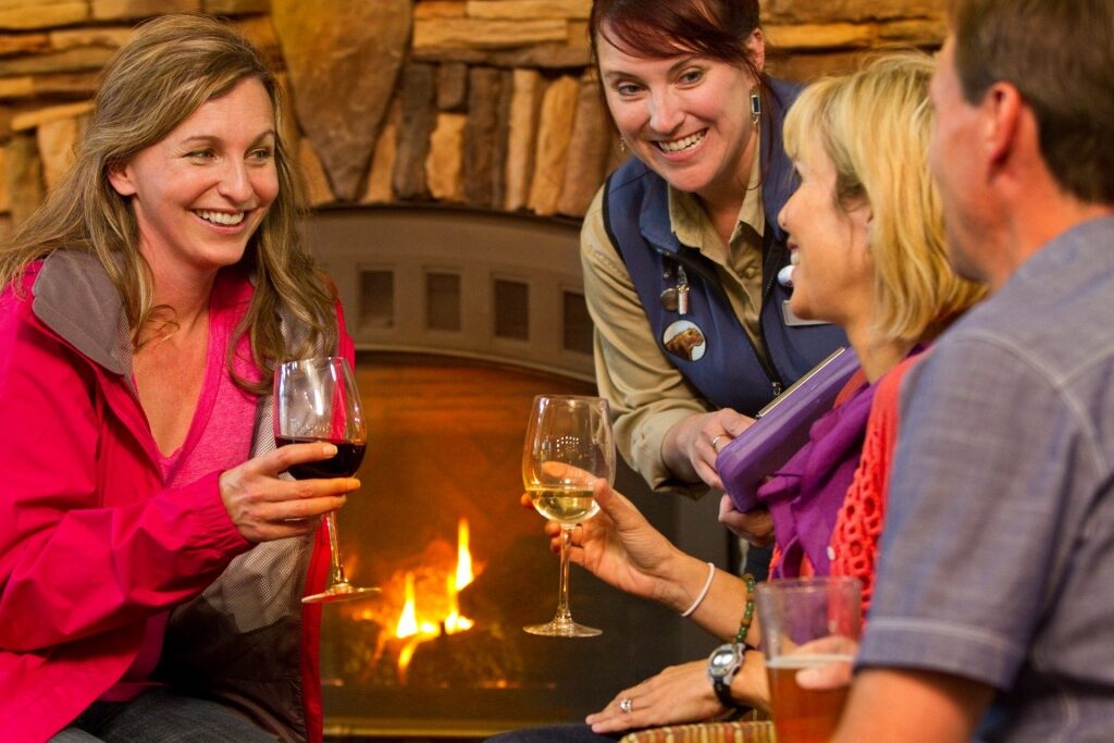 Women hanging out over wine