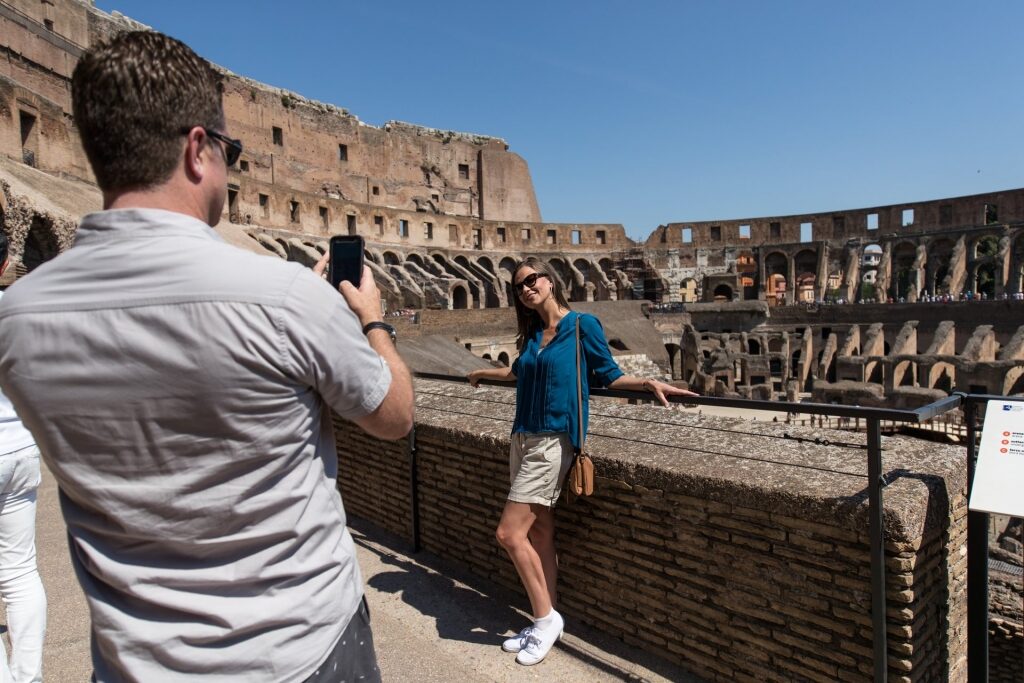 Couple taking a picture inside Colosseum
