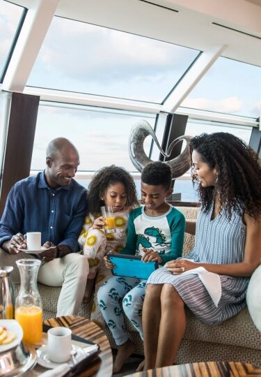 Family eating on a couch on a cruise ship