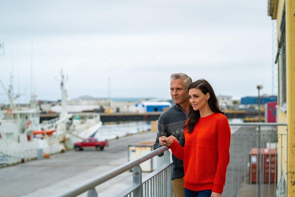 Couple wearing sweater standing in the balcony