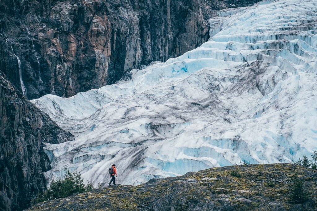 Woman trekking along Exit Glacier