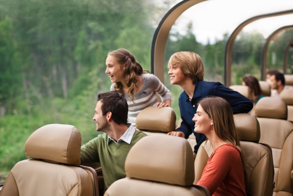 Family sightseeing from glass-domed trains in Alaska