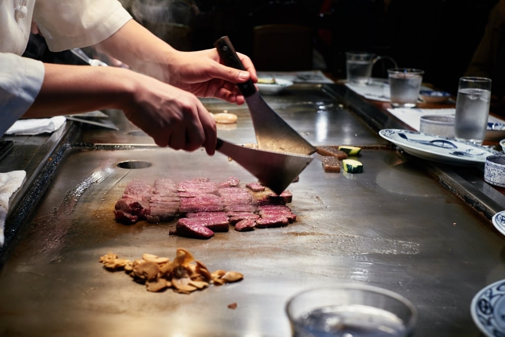 Chef preparing Kobe Steak at a teppanyaki restaurant