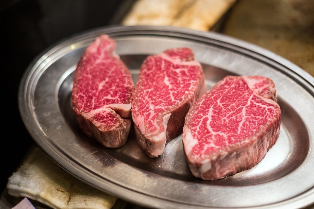 Thick slices of Kobe Beef on a plate to entice you on what to eat in japan