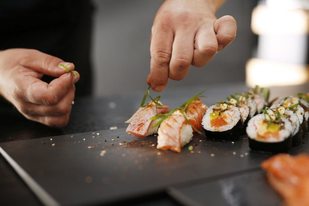 Chef putting final touch on sushi