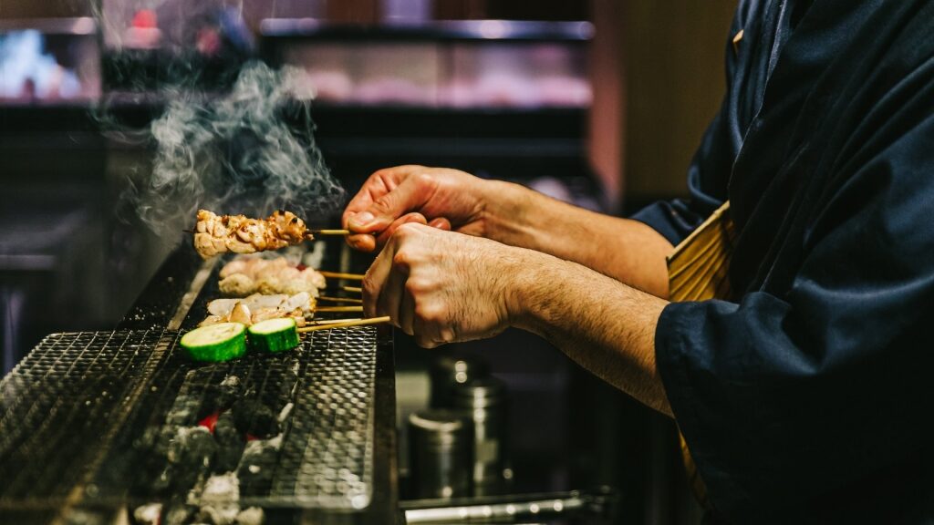 Yakitori Chef preparing different types of skewered chicken