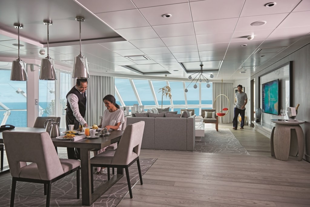 Woman being served with food inside cruise stateroom