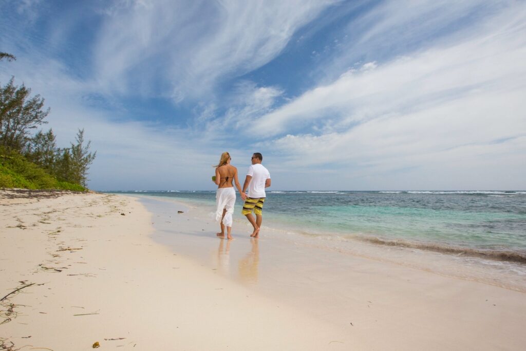 Couple walking on a beach in Falmouth, Jamaica