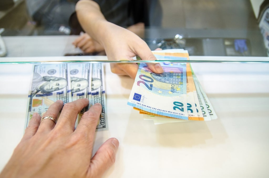 Woman exchanging dollars for euros