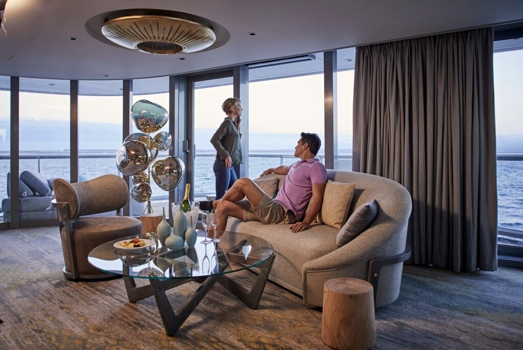 Couple relaxing inside Penthouse Suite on Celebrity