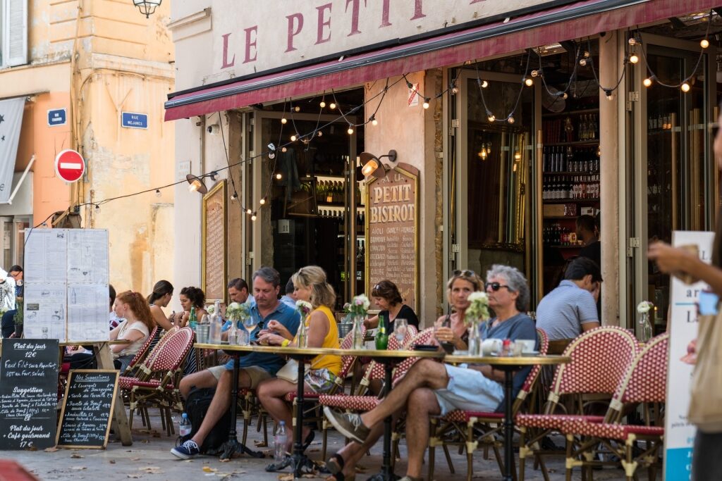 People eating and drinking wine at a restaurant in Provence