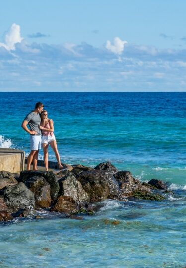 Couple on a rocky shore in Barbados
