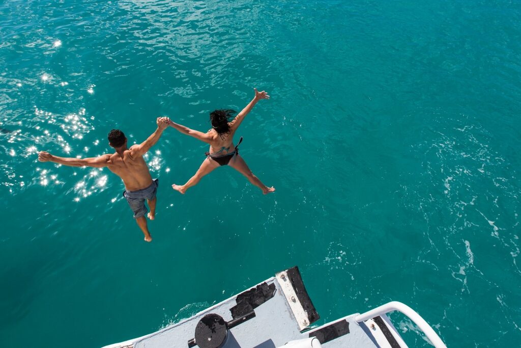 Couple jumping into the water