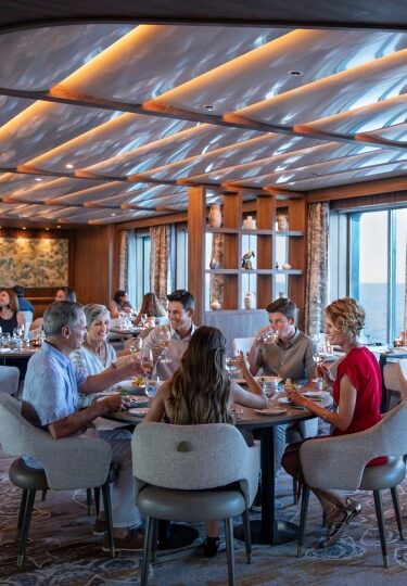 Guests eating inside Seaside Restaurant on Celebrity Flora