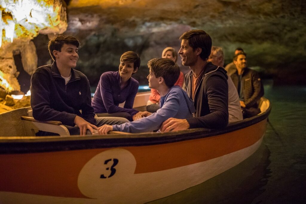 Family on a boat ride inside a cave with other guests