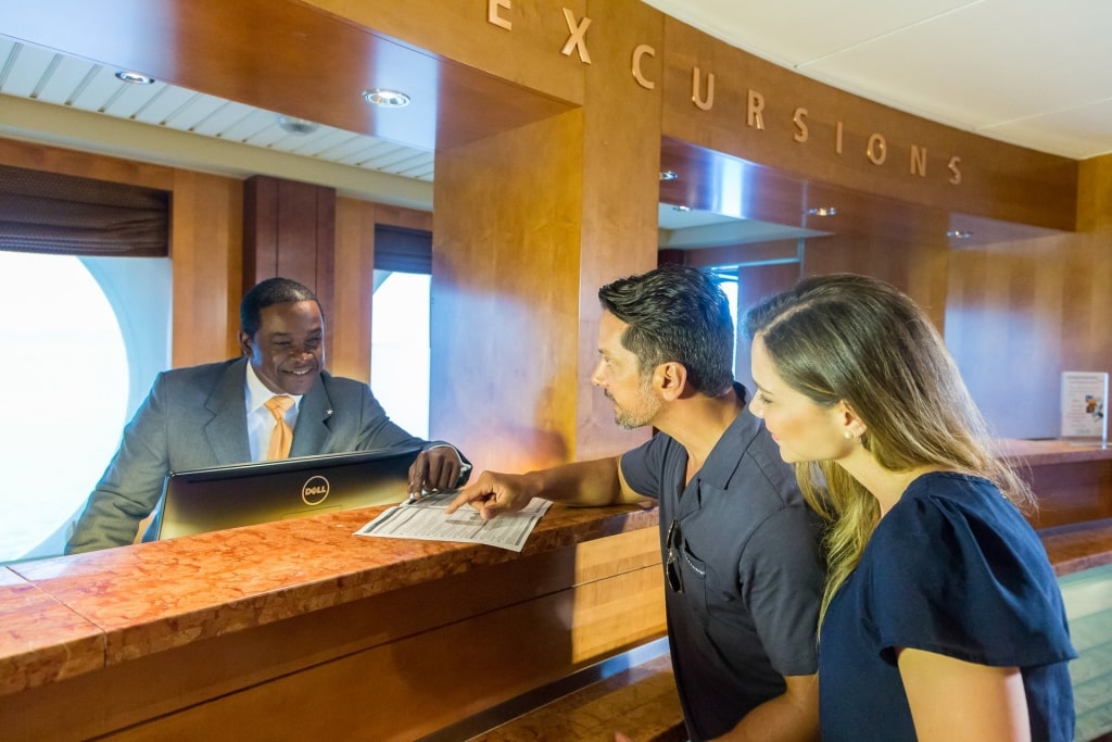 Couple signing up at the shore excursion counter