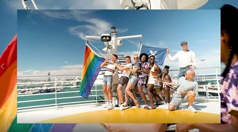 Gay people on a cruise with rainbow colored flag