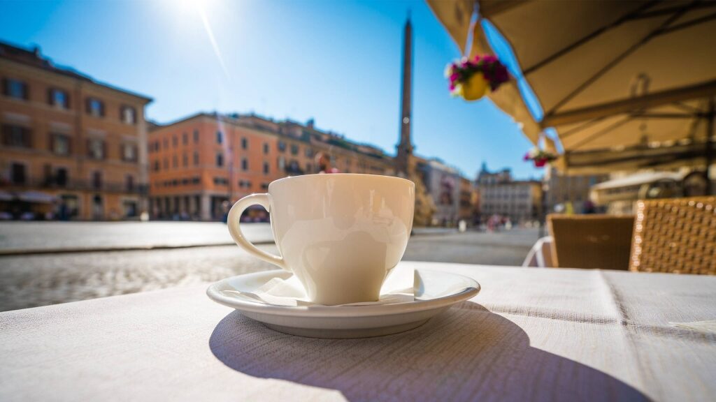 Cup of coffee with Italian buildings as backdrop