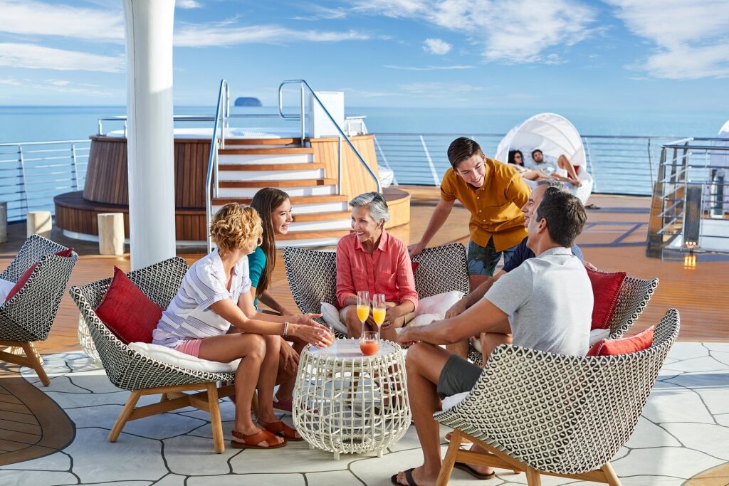 Family talking over drinks on a cruise