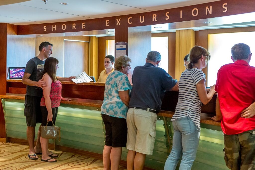 People signing up at the shore excursion counter