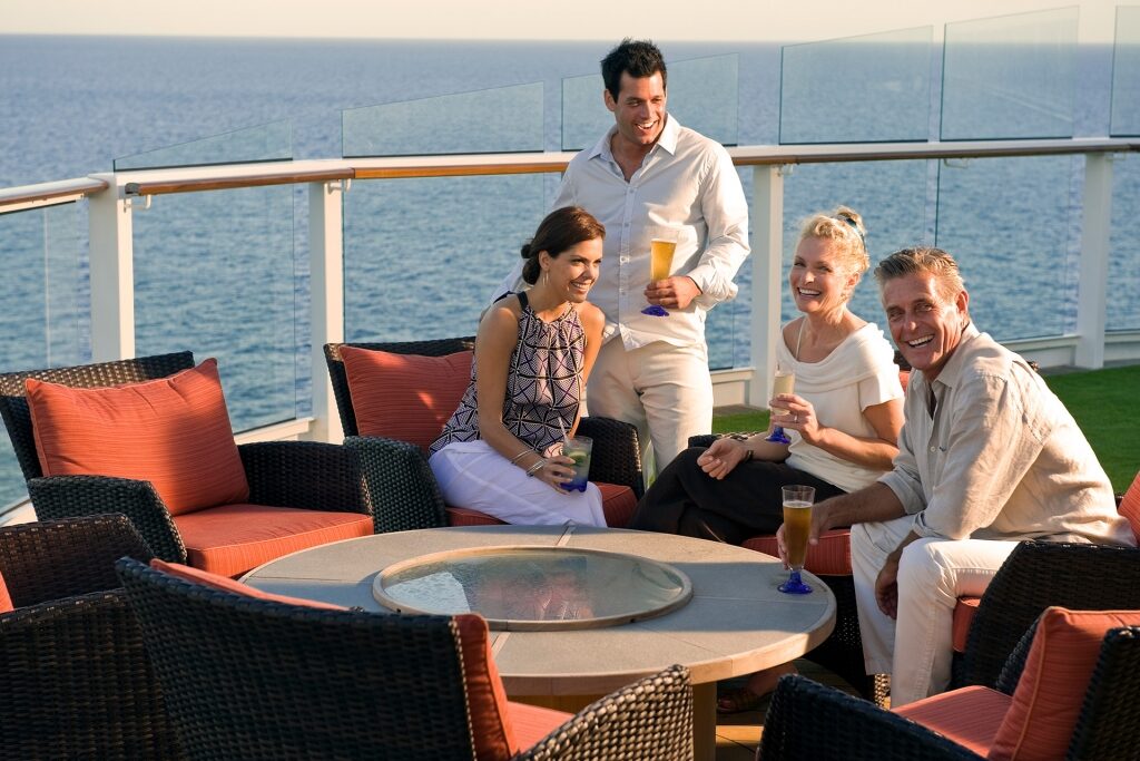 People hanging out at the Sunset Bar on a cruise