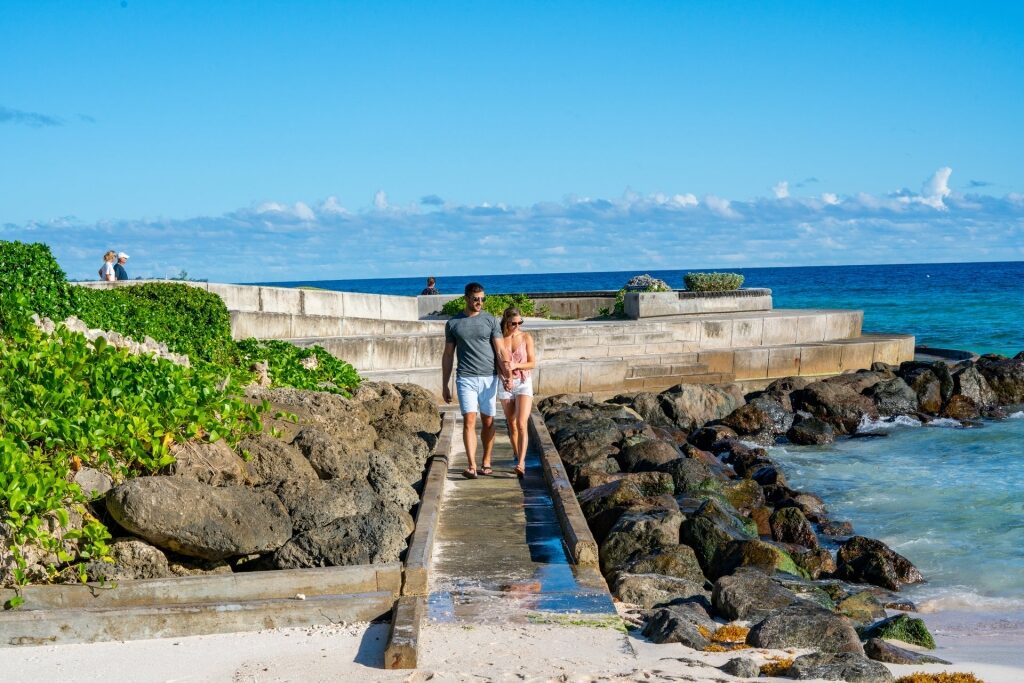 Couple walking on a boardwalk in Barbados