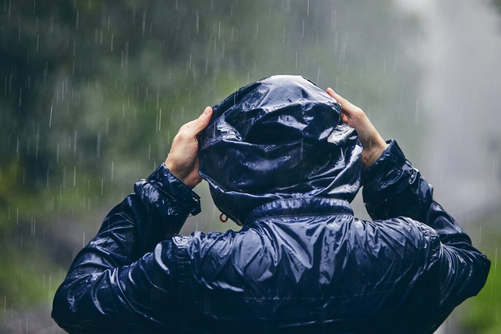 Man wearing black raincoat