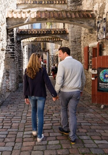Couple walking around historic streets of Estonia