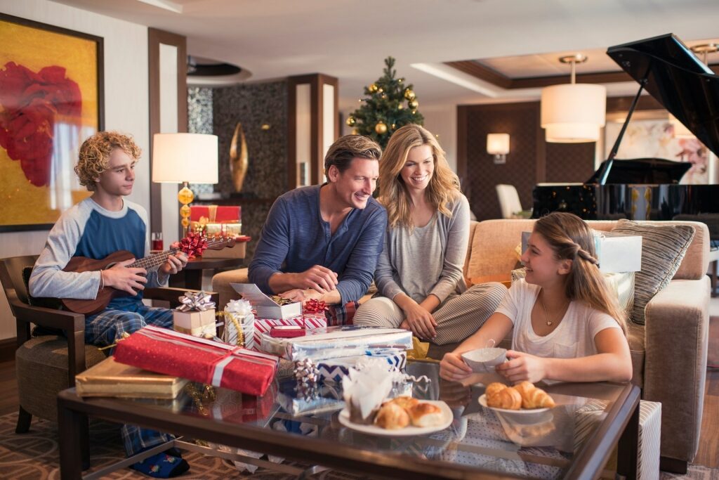 Family opening and exchanging gifts inside a stateroom