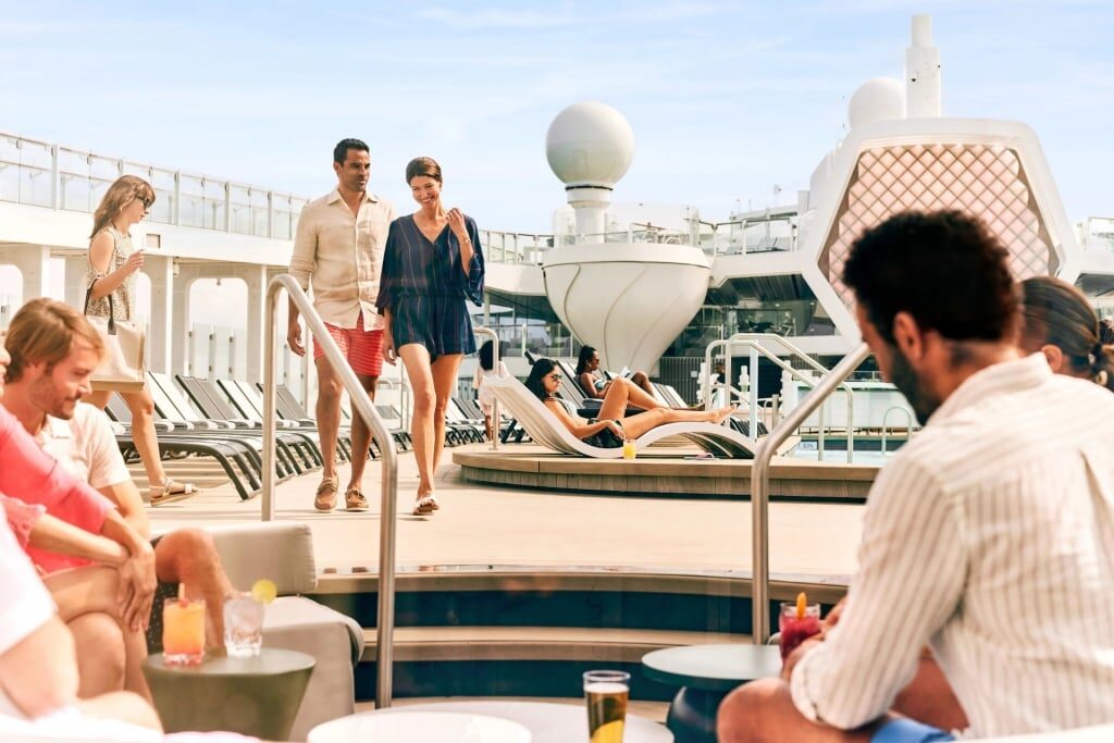 People relaxing on the resort deck of Celebrity Beyond