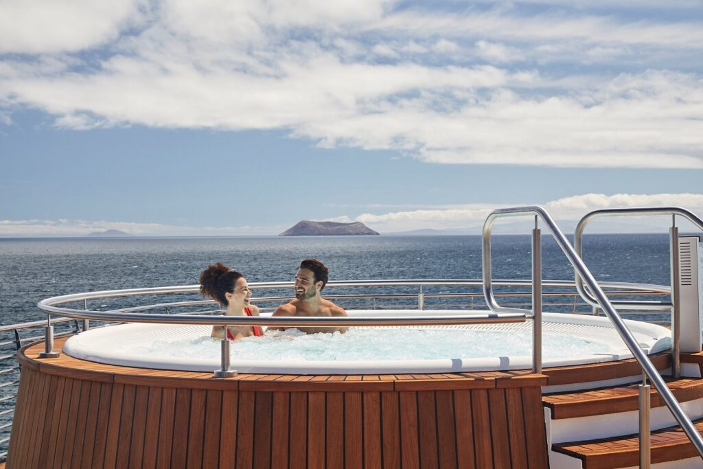 Couple inside a jacuzzi while on a cruise