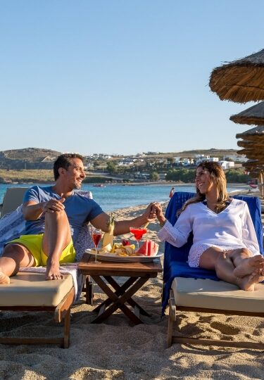 Couple relaxing at a beach in Mykonos