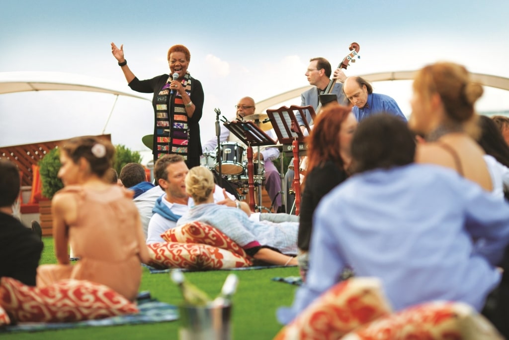 People hanging out at the Lawn Club with live music on Celebrity Edge 