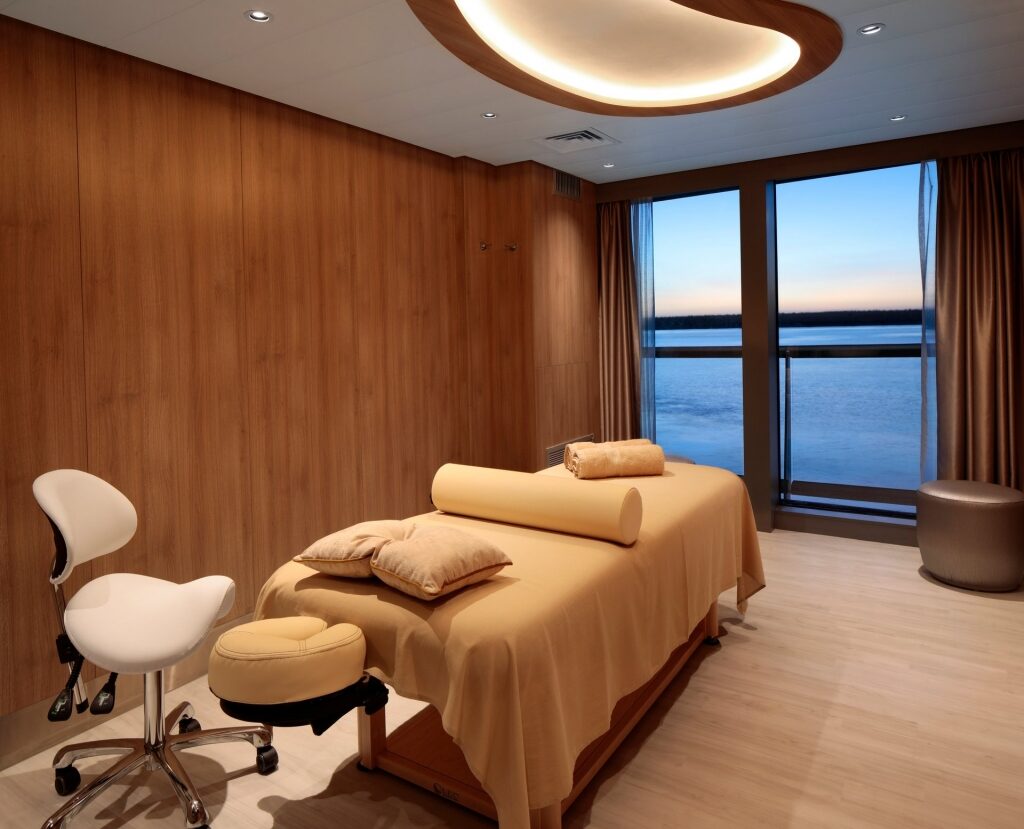 Celebrity Edge spa bed on a cruise with glass wall for relaxing sea view 