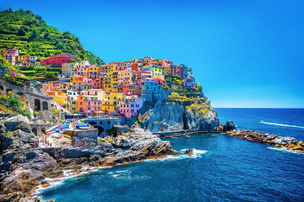 Colorful houses residing on a rock over Mediterranean sea in Liguria, Italy