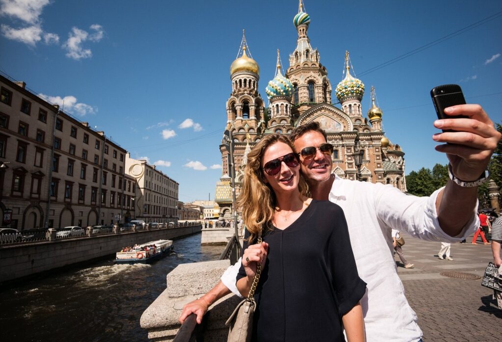 Couple taking a selfie with Spilled Blood Cathedral as backdrop