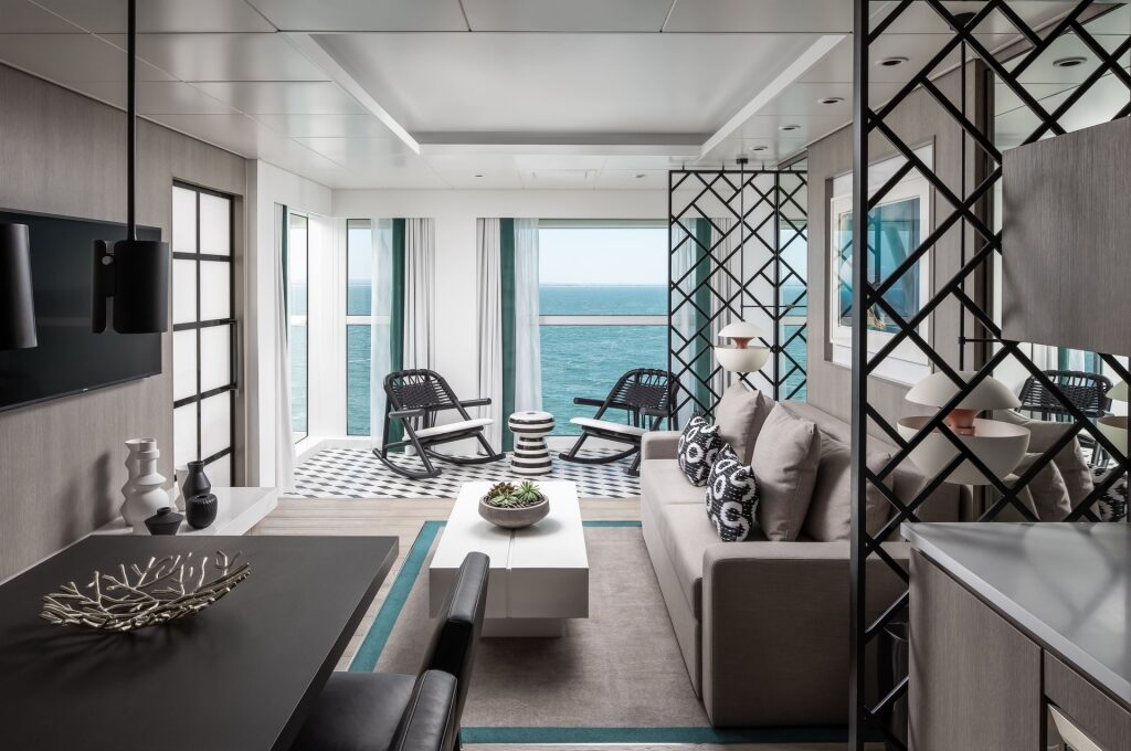 Spacious interior of Celebrity Edge Royal Suite living and dining areas with large windows