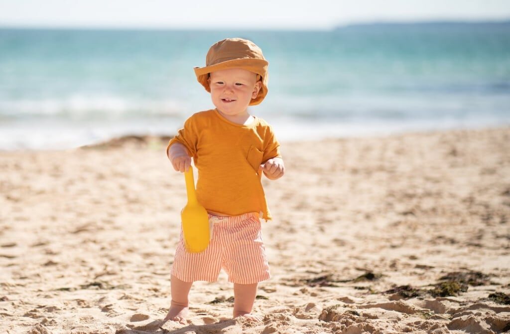Toddler playing on sandy beach