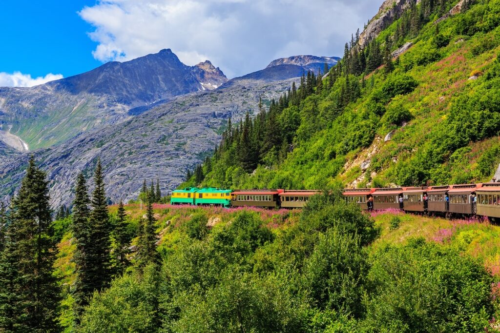 Train in Skagway, Alaska including mountains and pine trees