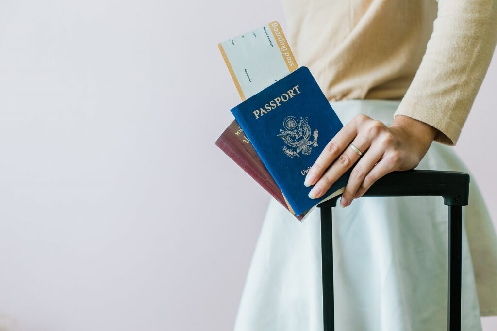 Woman holding passport and ticket