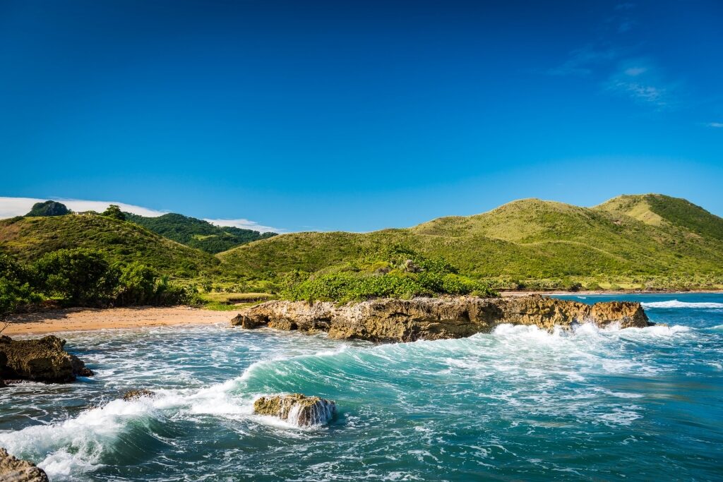 Landscape view of Puerto Plata with large waves on rocky shore 