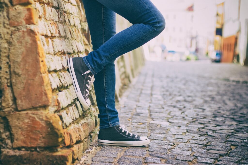 Person standing with jeans and sneakers
