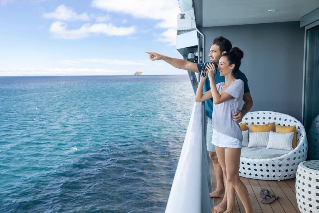 Couple using binocular while sightseeing on a cruise