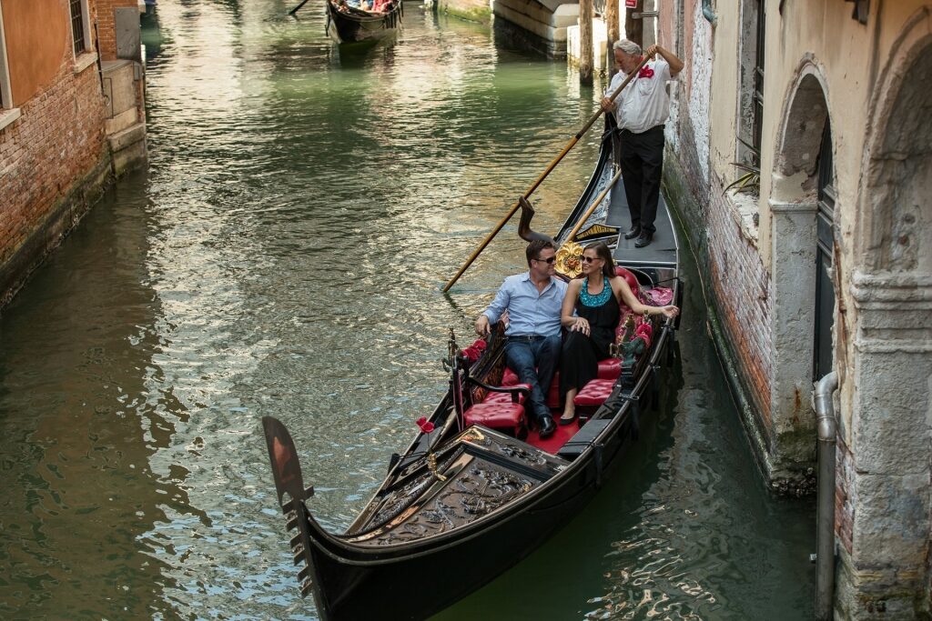 Couple enjoying a romantic gondola ride in Venice