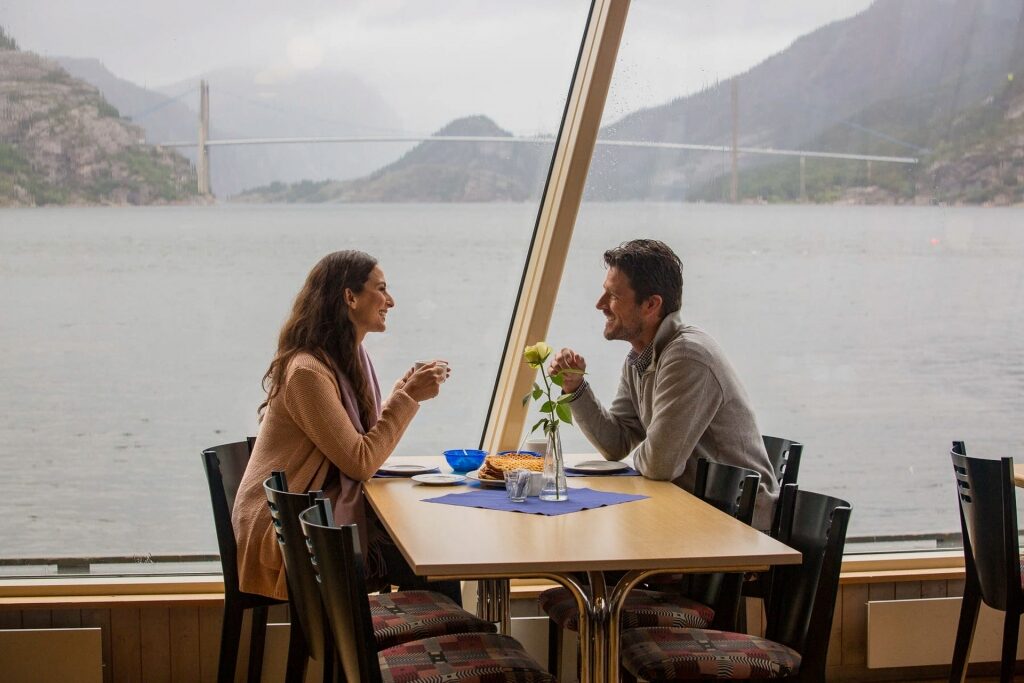 Couple enjoying coffee by the window on a cruise